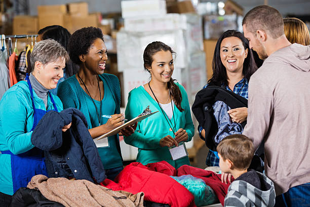 diverse group of volunteers working at charity clothing drive together